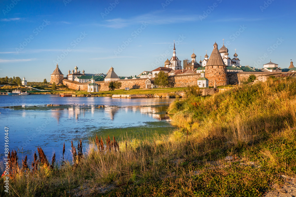 Solovetsky Monastery and yellow autumn grass on the shore