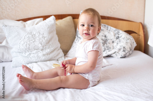 little cute girl playing in bed laughing and smiling