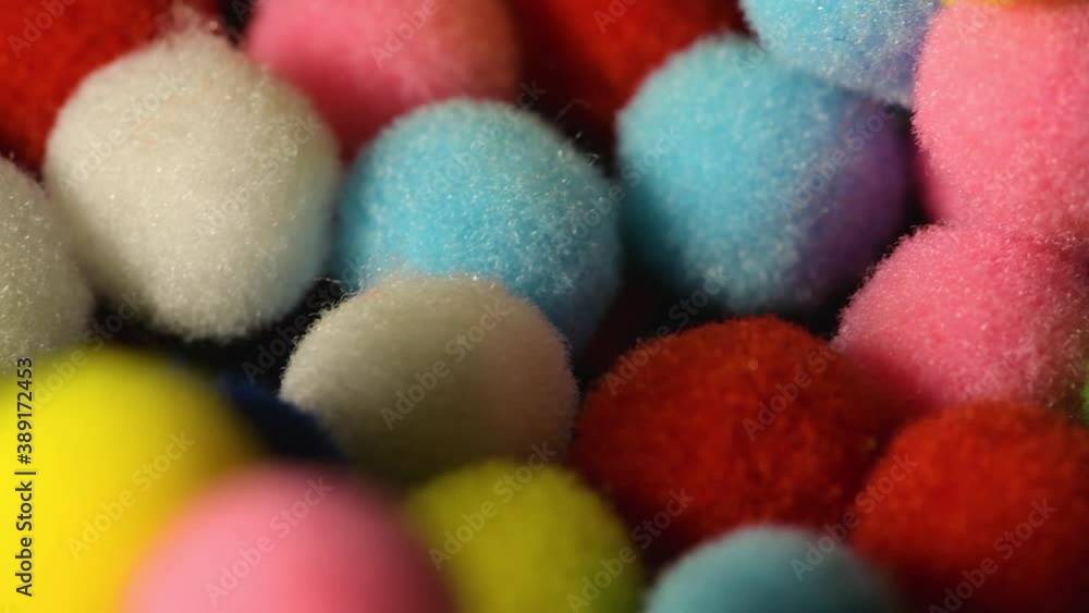 Fluffy and colorful little balls on black background Fluffy and colorful little balls on black background