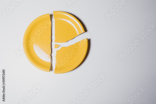 broken yellow plate on the table