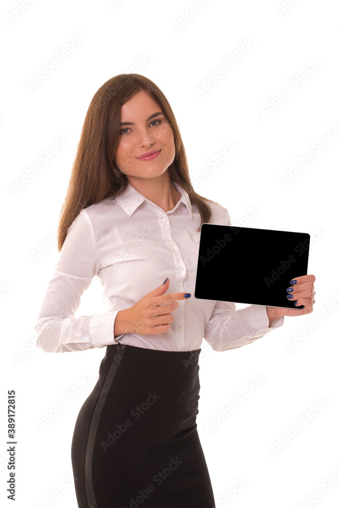 Beautiful brunette stands on a white background with a tablet in her hands. Girl looks at the camera and holds a gadget in her hands. Beautiful brunette stands on a white background with a tablet in her hands. Girl looks at the camera and holds a gadget in her hands.