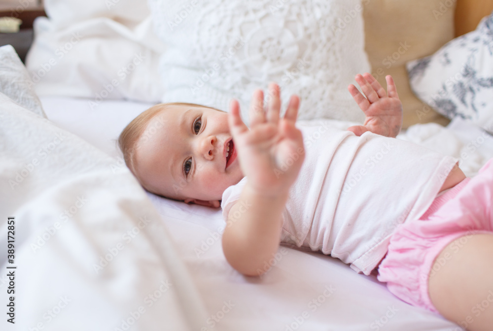 little cute girl playing in bed laughing and smiling little cute girl playing in bed laughing and smiling