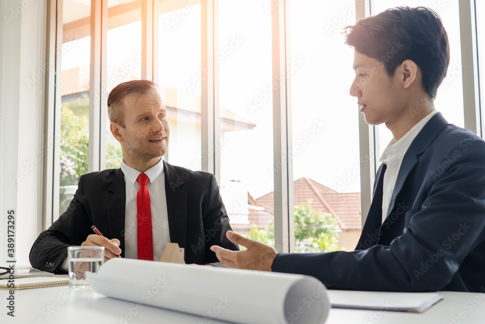 Two businessmen shaking hands after deal contract to mortgage real estate. Two businessmen shaking hands after deal contract to mortgage real estate.