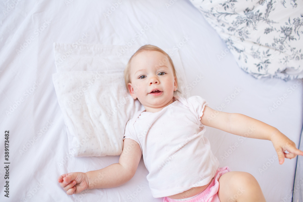little cute girl playing in bed laughing and smiling little cute girl playing in bed laughing and smiling