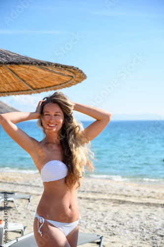 Happy young woman resting at the beach in Asprovalta