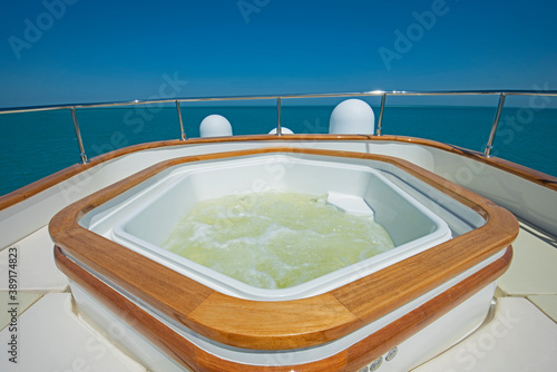 View over the bow over a large motor yacht with hot tub © Paul Vinten
