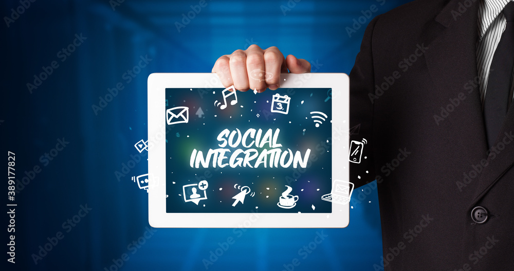 Young business person working on tablet and shows the inscription: SOCIAL INTEGRATION Young business person working on tablet and shows the inscription: SOCIAL INTEGRATION