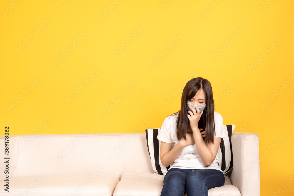 Obraz premium Young asian woman wearing face mask under the outbreak sneezing