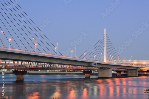 Long exposure urban landscape of suspension bridge in dusk sky background