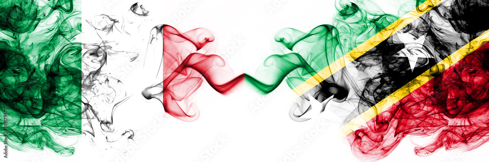 Italy vs Saint Kitts and Nevis smoky mystic flags placed side by side. Thick colored silky abstract smoke flags