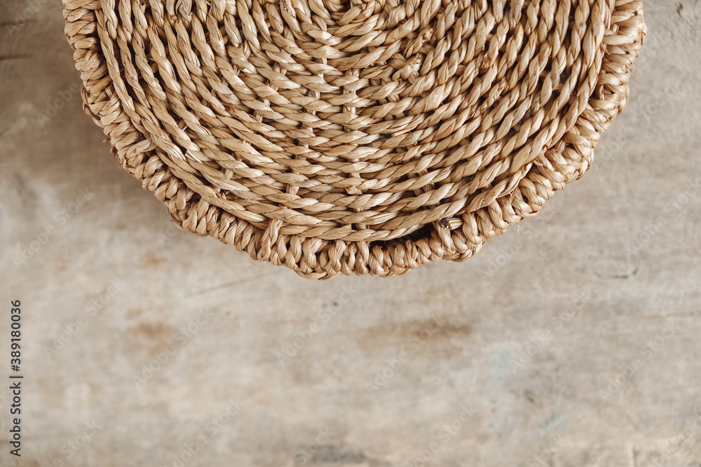 Details of a round wicker basket on an old wooden background. Top view. Copy, empty space for text