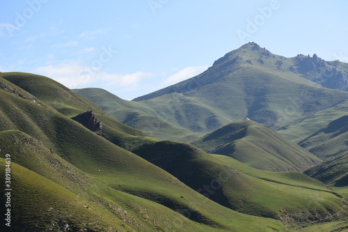 Panoramic view of green mountains, blue skies, light clouds, autumn, Qinghai, China