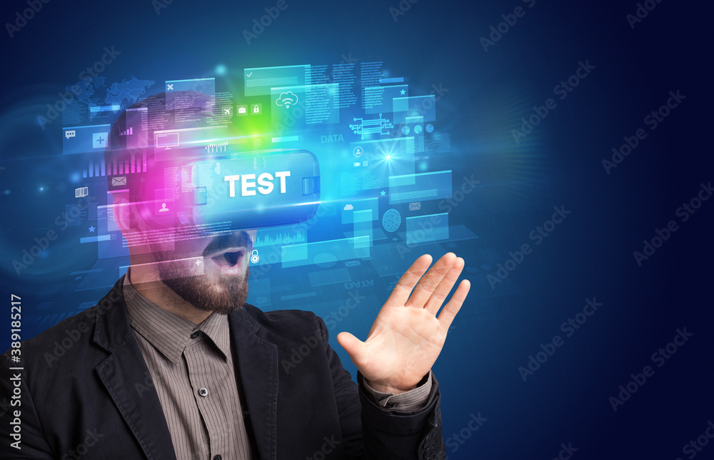 Businessman looking through Virtual Reality glasses with TEST inscription, innovative security concept Businessman looking through Virtual Reality glasses with TEST inscription, innovative security concept