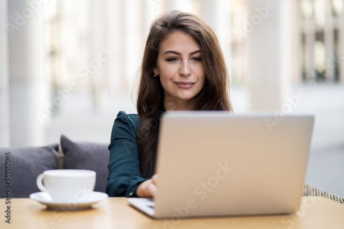 writes the text in the laptop task for a new task from the teacher. young female student of Caucasian appearance brunette studying remotely, on the table a Cup of hot coffee Americano cappuccino Free Download writes the text in the laptop task for a new task from the teacher. young female student of Caucasian appearance brunette studying remotely, on the table a Cup of hot coffee Americano cappuccino - GFXLoad