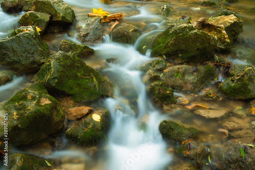 Fototapeta Naklejka Na Ścianę i Meble -  The stream of water in the river flowing between the rocks , long exposure photo
