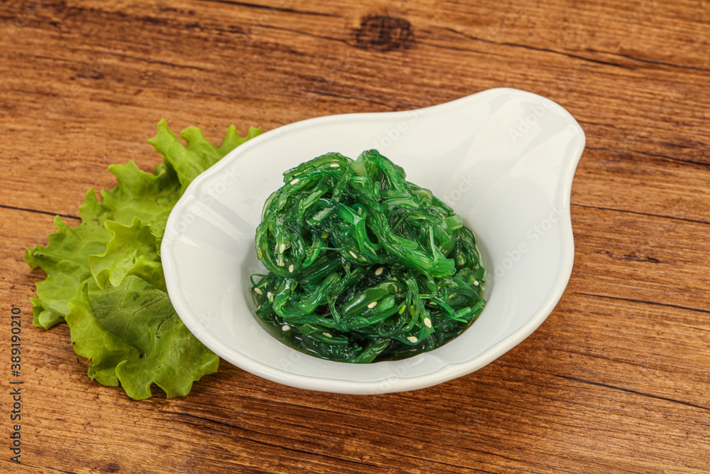 Green Chuka Seaweed Salad Isolated on White Background Top View. Wakame Sea Kelp Salat Green Chuka Seaweed Salad Isolated on White Background Top View. Wakame Sea Kelp Salat