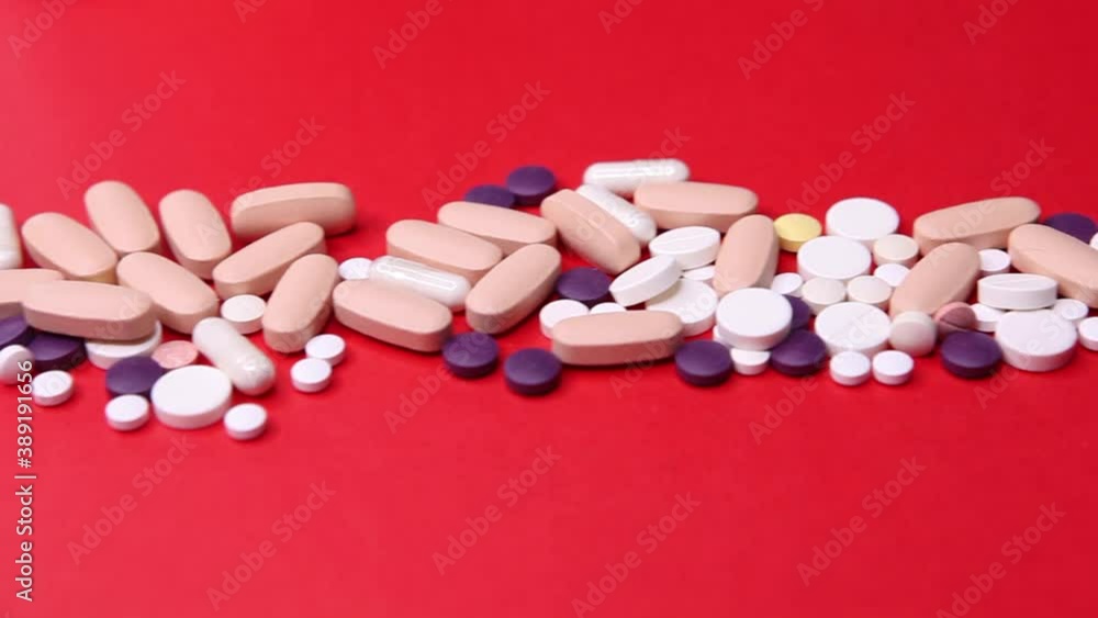 Various pills macro on red background. Top view Various pills macro on red background. Top view