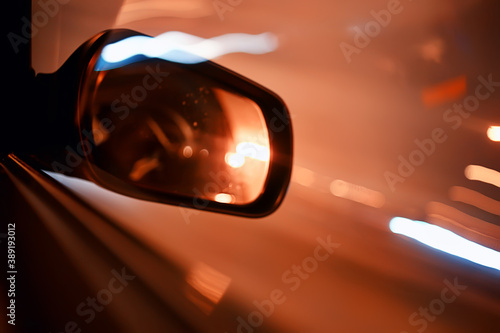 night trip on car background, abstract blurred rear view mirror urban road © kichigin19