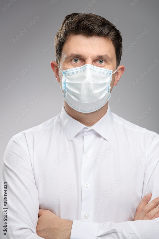 Man in protective face mask, office worker in white shirt wearing mask to protect against covid-19. Man in protective face mask, office worker in white shirt wearing mask to protect against covid-19.