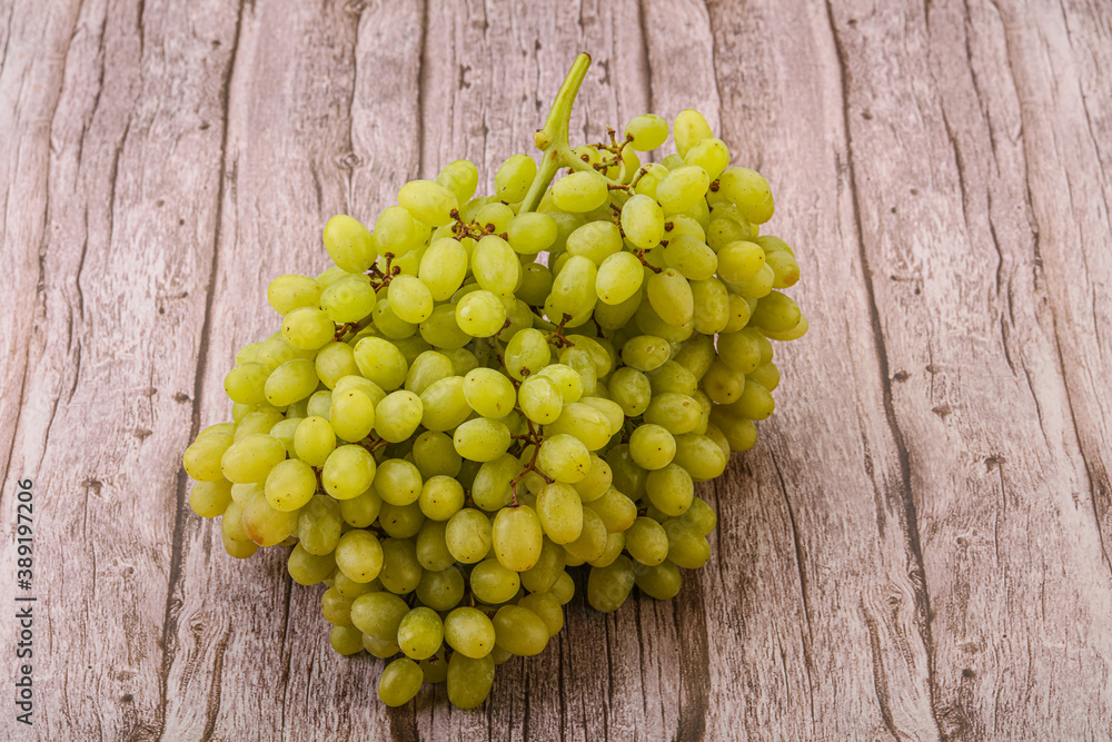 Green grape branch over background Green grape branch over background