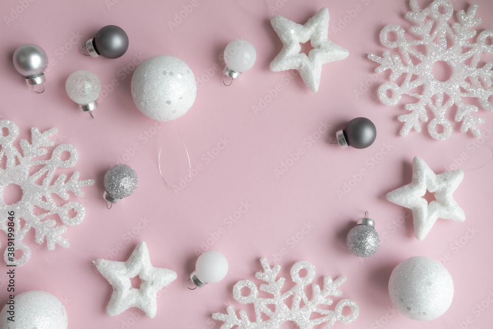 New Year's composition. Christmas pink and white decorations on a pastel pink background with space for text. Layout of a postcard, poster. New Year's composition. Christmas pink and white decorations on a pastel pink background with space for text. Layout of a postcard, poster.