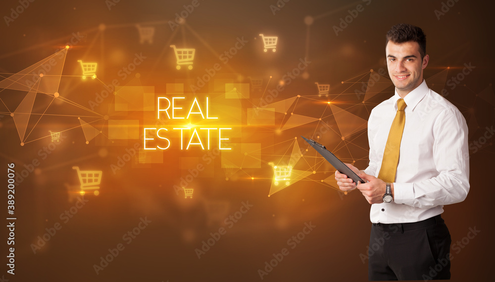 Businessman with shopping cart icons and REAL ESTATE inscription, online shopping concept Businessman with shopping cart icons and REAL ESTATE inscription, online shopping concept