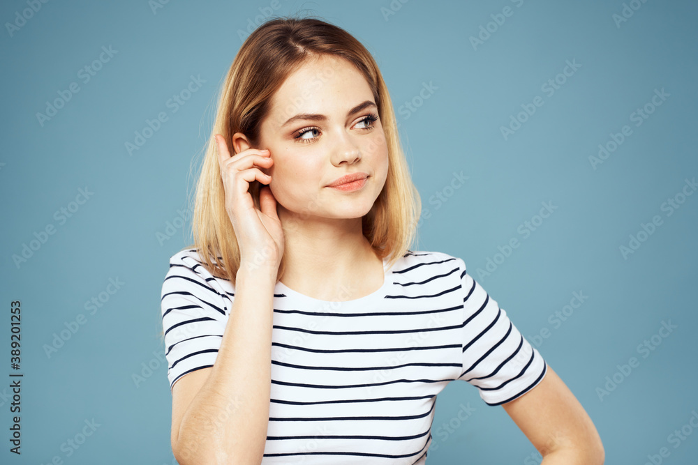 Blonde girl in striped t-shirt lifestyle blue background fun Blonde girl in striped t-shirt lifestyle blue background fun