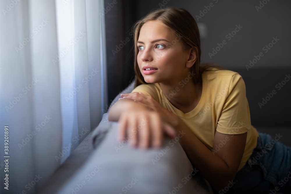 Beauty woman with white perfect smile looking at camera relaxing at couch at home Beauty woman with white perfect smile looking at camera relaxing at couch at home
