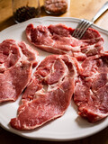Raw pork chops on plate