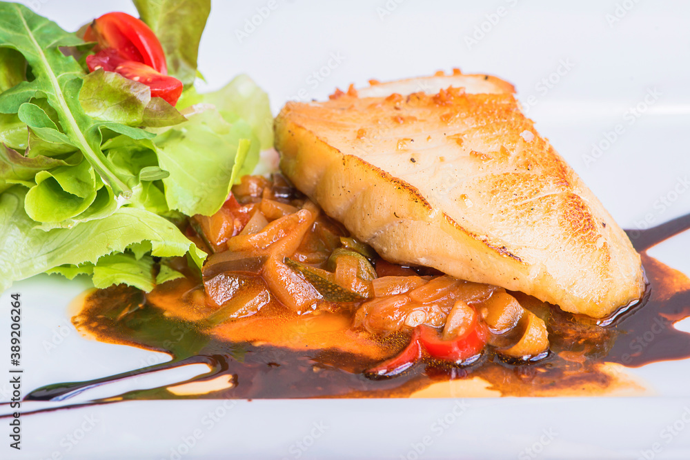 Delicious healthy grilled fish fillet served on a platter with a colorful fresh salad for a tasty seafood. Grilled Snow fish Delicious healthy grilled fish fillet served on a platter with a colorful fresh salad for a tasty seafood. Grilled Snow fish