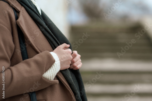 female hands that hold a scarf. Outside
