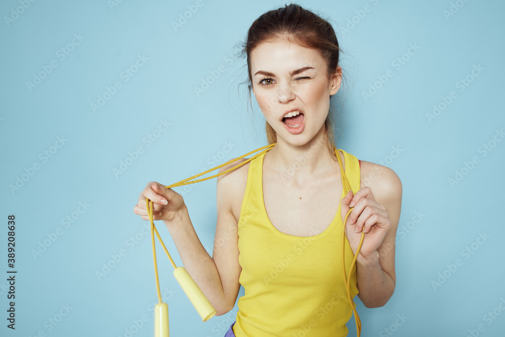 Sportive woman skipping rope exercise gym fitness blue background Sportive woman skipping rope exercise gym fitness blue background