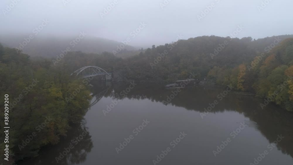 Drone flies above bridge next to Veveri castle in Czech Republic. Morning fog. Drone flies above bridge next to Veveri castle in Czech Republic. Morning fog.
