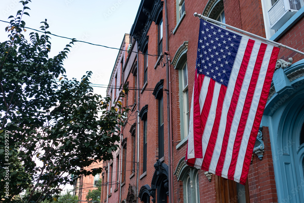American Flag Hanging Outside a Row of Beautiful Red Brick Homes in Hamilton Park of Jersey City