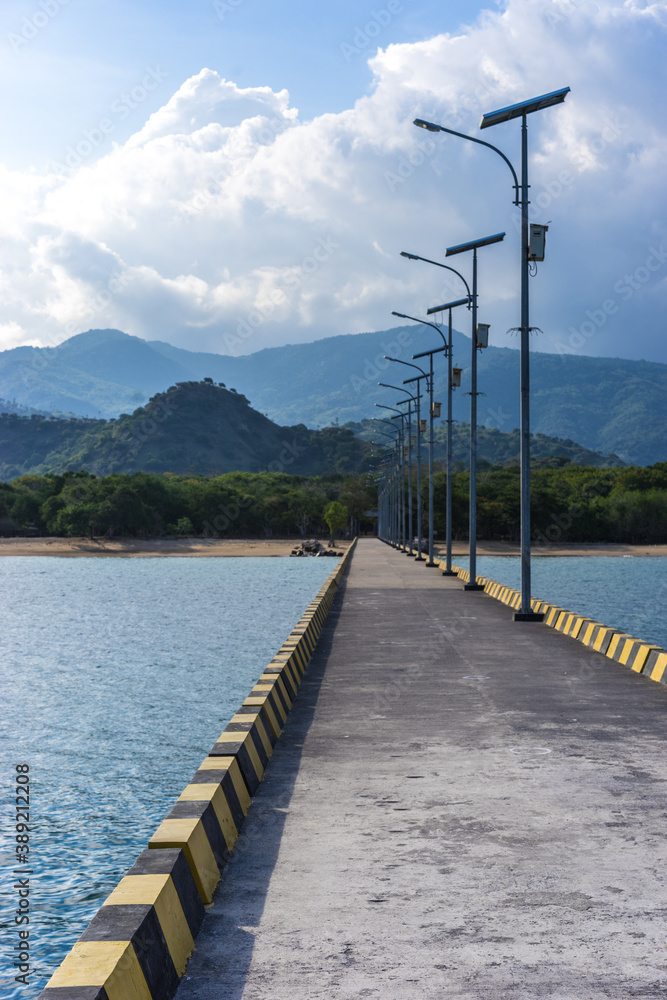 Newly built long pier on the sea with solar panels and lights, green power technology in Asia