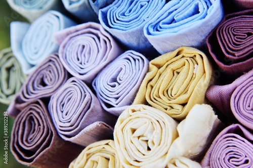 rolls of multicolored fabrics close-up.