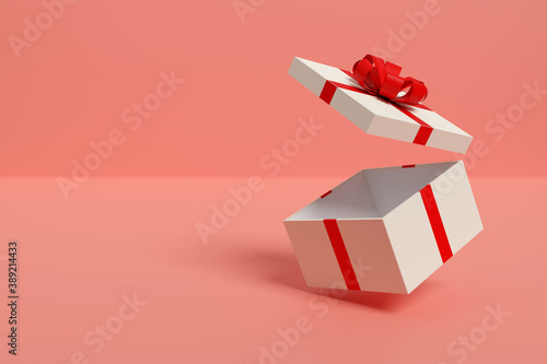 Fotografie White gift box with red bow isolated on a pink background
