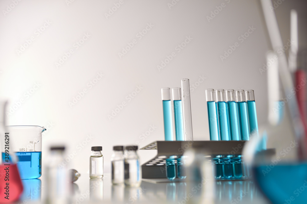 Vaccine vial search concept on table around chemical glassware Vaccine vial search concept on table around chemical glassware