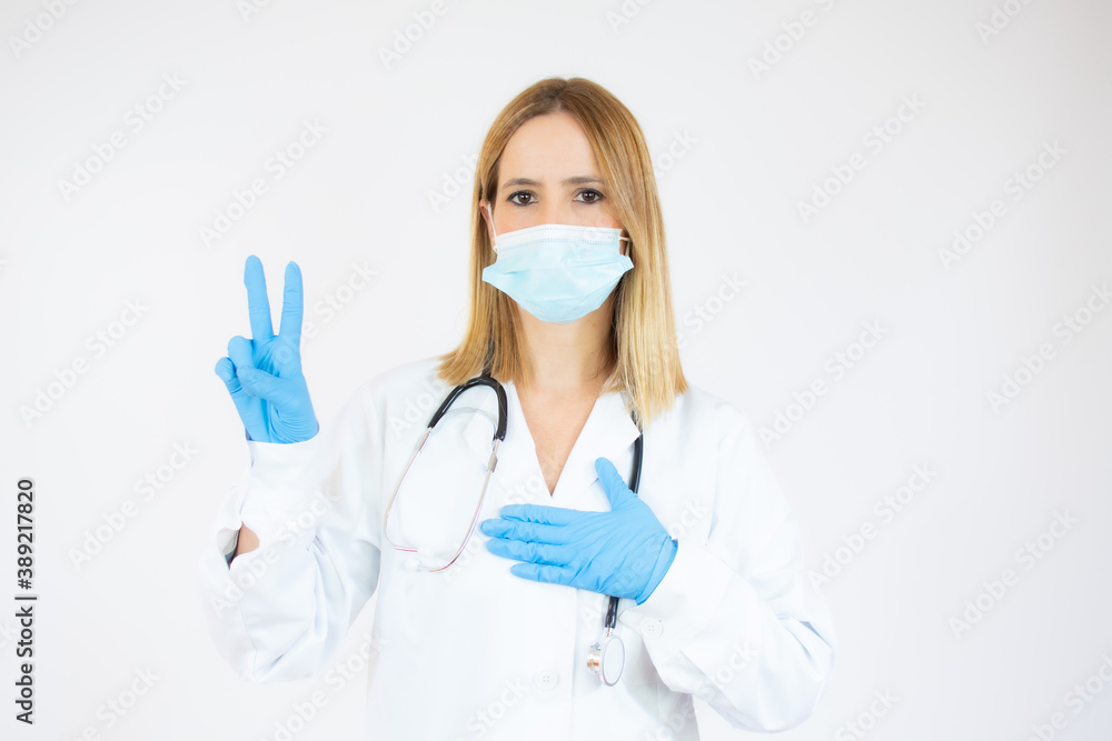 Beautiful female doctor or nurse wearing protective mask and latex or rubber gloves on white background with copy space. Health care concept Beautiful female doctor or nurse wearing protective mask and latex or rubber gloves on white background with copy space. Health care concept