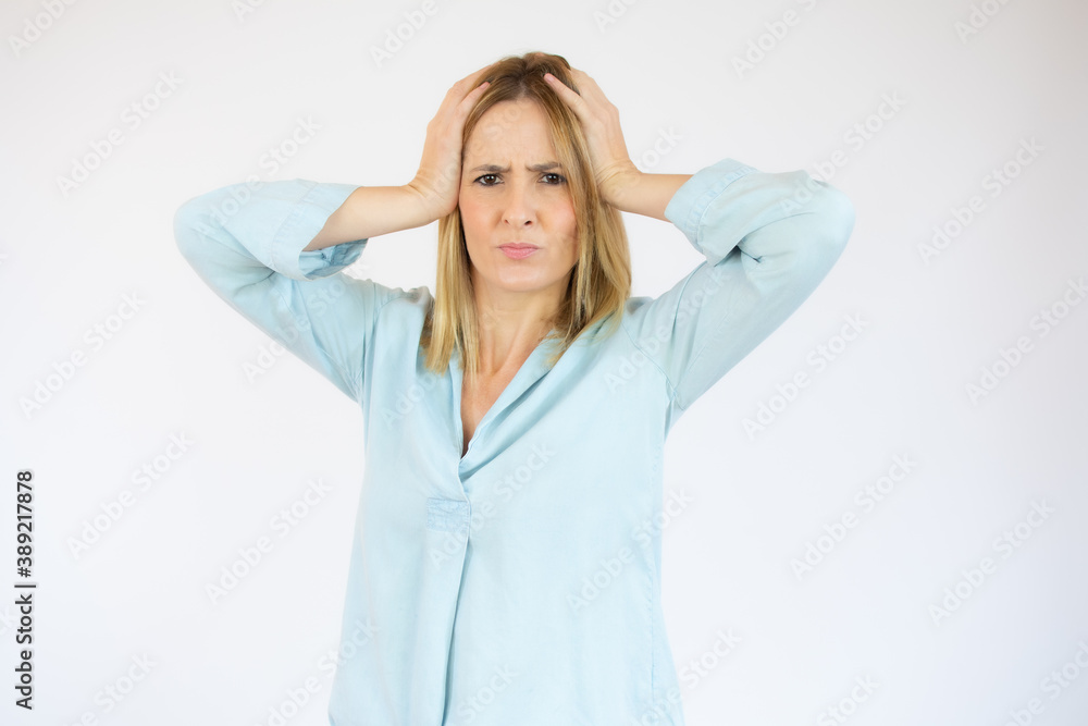 Young woman in casual clothes doubting over white background.