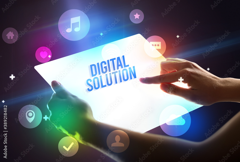 Holding futuristic tablet with DIGITAL SOLUTION inscription, new technology concept Holding futuristic tablet with DIGITAL SOLUTION inscription, new technology concept