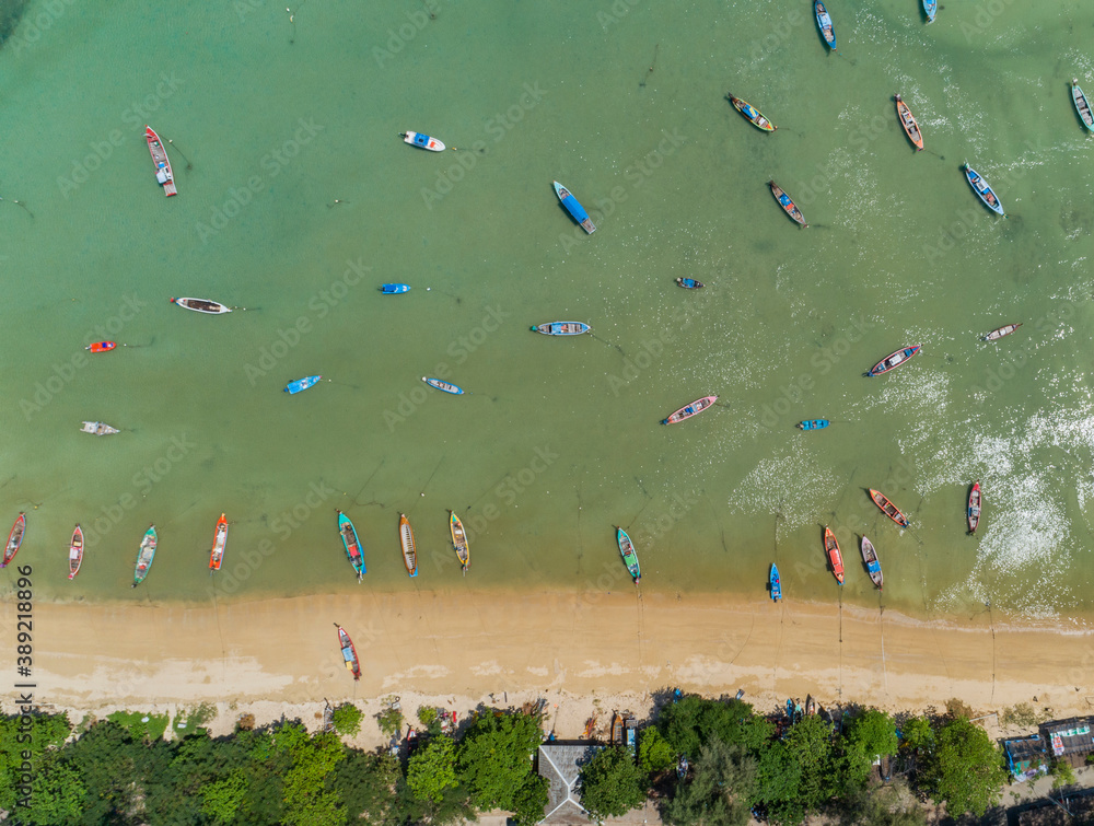 Aerial drone bird's eye view photo Top down of tropical sea with long tail fishing boats at phuket thailand.