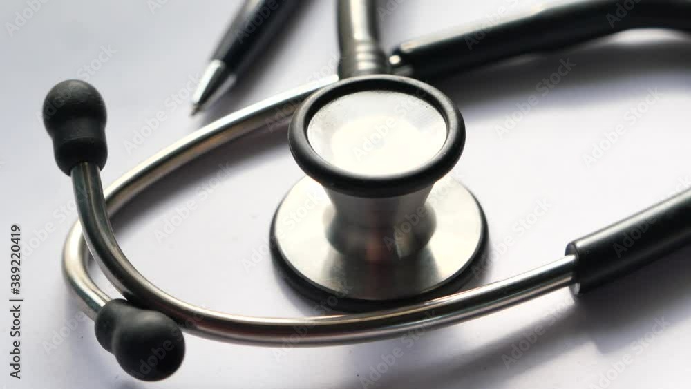 close up of stethoscope, paper and pen on clinic desk close up of stethoscope, paper and pen on clinic desk