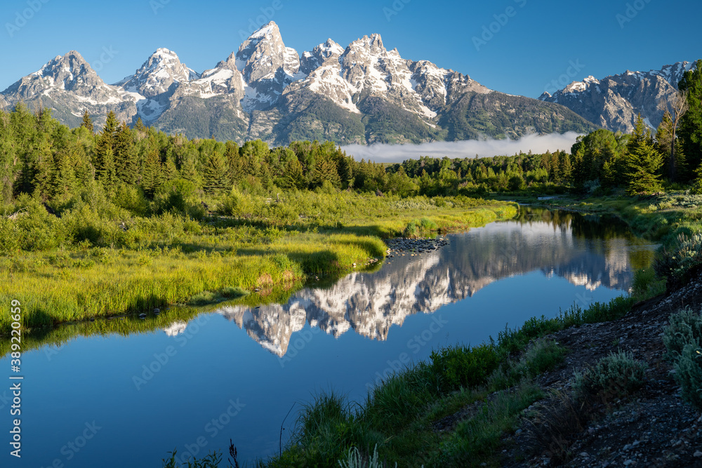 Schwabacher Landing in the early morning in Grand Teton National Park, with mountain reflections on the water creek