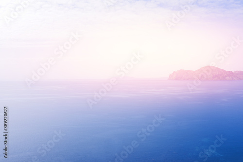 Seascape overlooking the mountain. Colorful sky over the ocean.