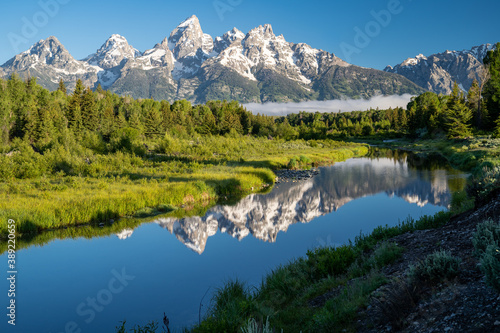Fototapeta Naklejka Na Ścianę i Meble -  Schwabacher Landing in the early morning in Grand Teton National Park, with mountain reflections on the water creek
