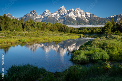 Fototapeta Naklejka Na Ścianę i Meble -  Schwabachers Landing in the early morning in Grand Teton National Park, with mountain reflections on the water creek