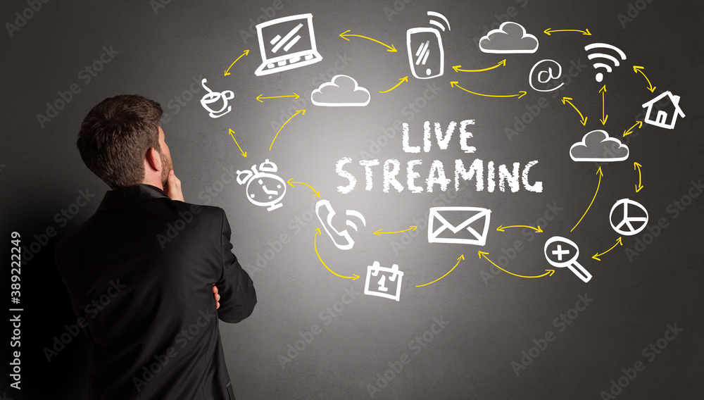 businessman drawing social media icons with LIVE STREAMING inscription, new media concept businessman drawing social media icons with LIVE STREAMING inscription, new media concept