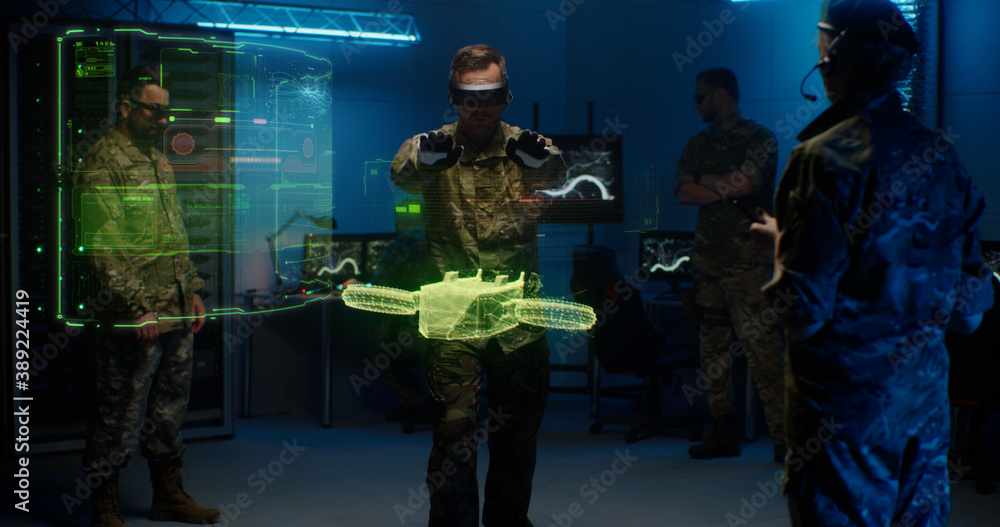 Military men controlling holographic model of drone
