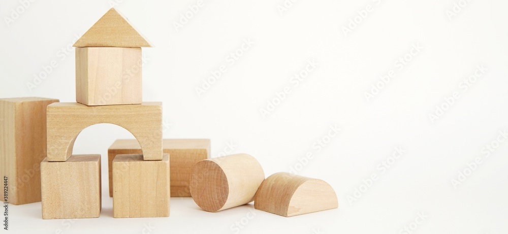 Obraz premium Wooden kids toys, building blocks on white background, banner, space for text.
